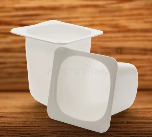 empty-crushed-plastic-yogurt-pots-wooden-background-74086664
