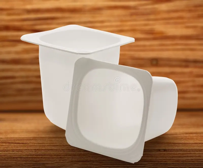 empty-crushed-plastic-yogurt-pots-wooden-background-74086664